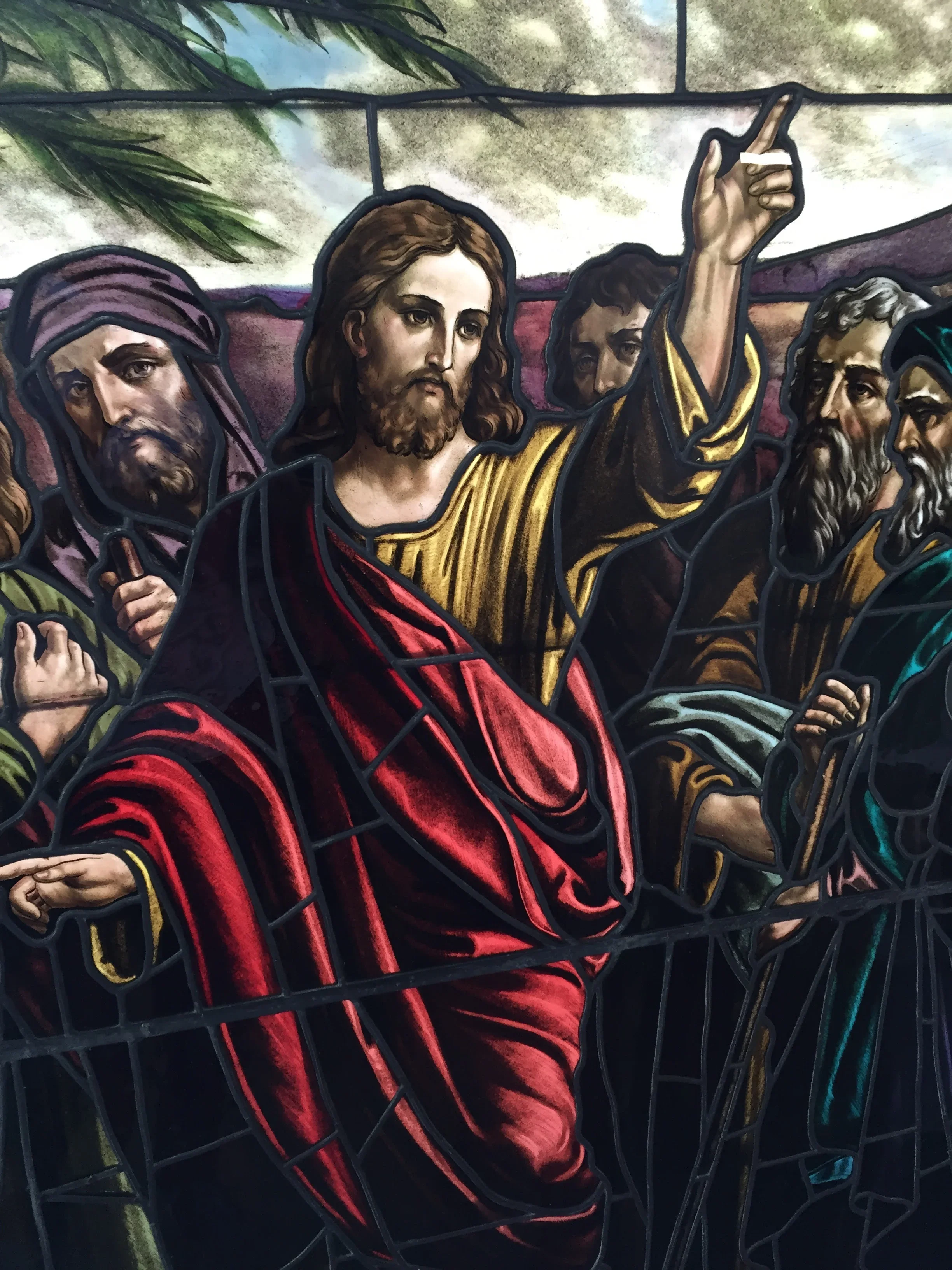 Stained glass window depicting religious figures with vibrant colored glass and lead came
