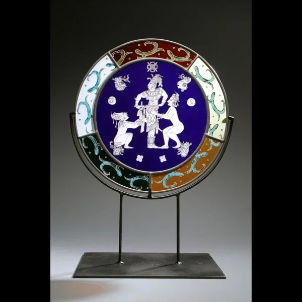 Decorative glass disc with white enamel figures on cobalt blue, ornate colored borders, mounted on metal stand
