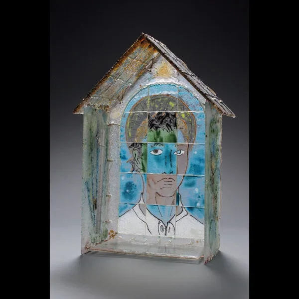 Artistic glass panel with segmented portrait and blue glass accents in wooden frame