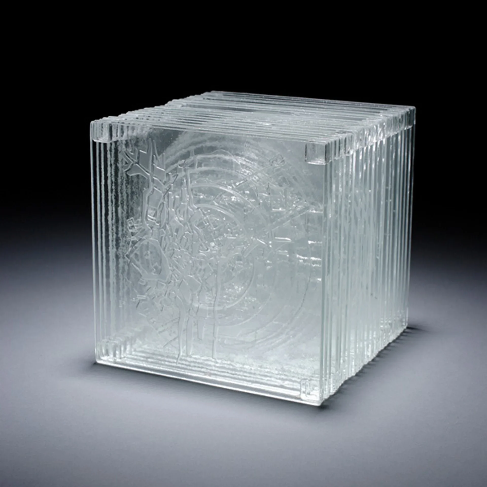 Clear glass block with etched celestial and decorative patterns throughout