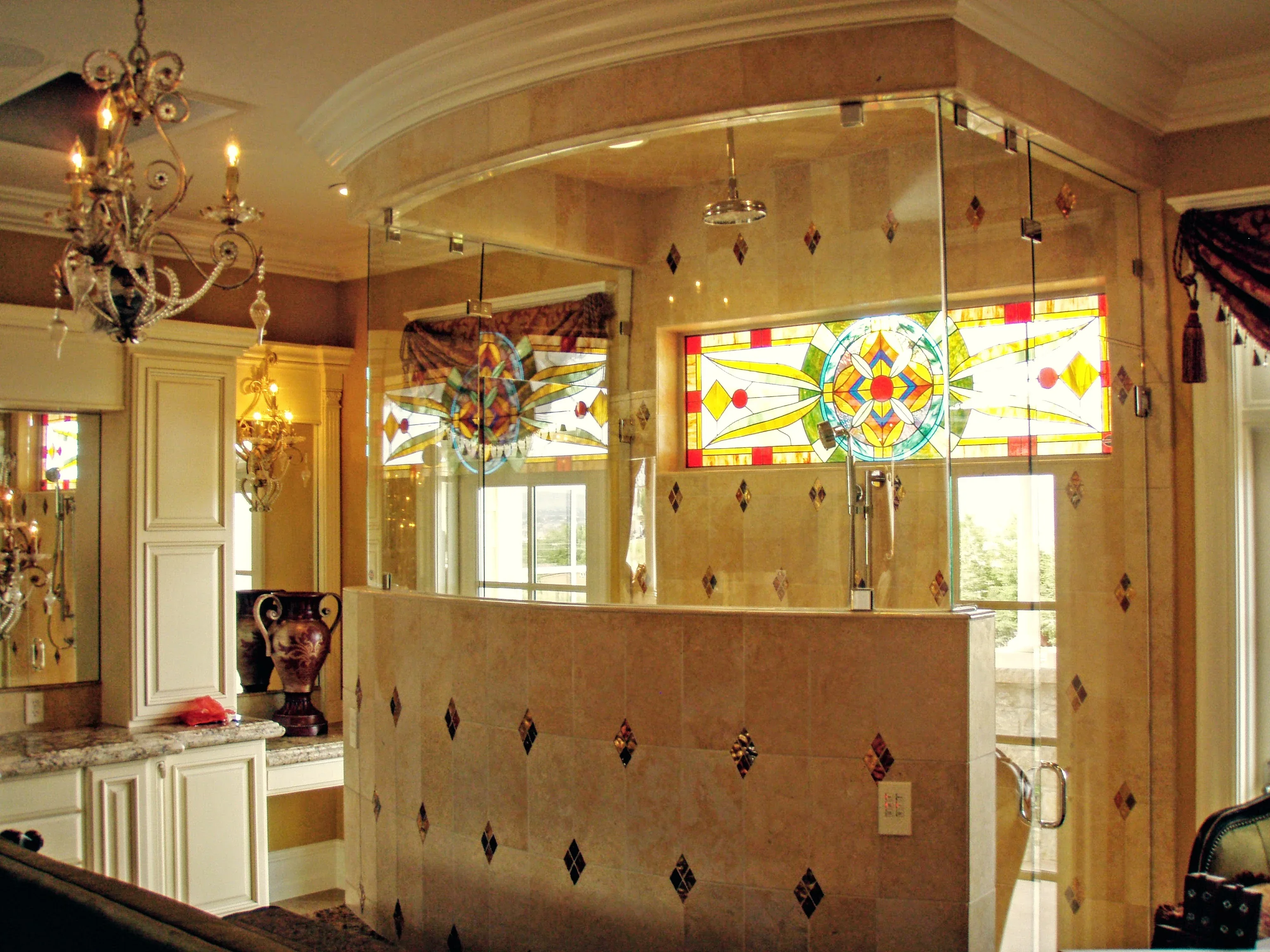 Frameless shower with stained glass transom and decorative tile accents